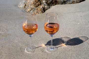 Summer time in Provence, two glasses of cold rose wine on sandy beach near Saint-Tropez, Var department, France