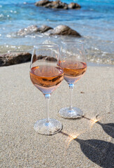 Summer time in Provence, two glasses of cold rose wine on sandy beach near Saint-Tropez, Var department, France