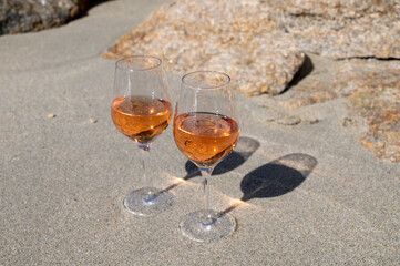 Summer time in Provence, two glasses of cold rose wine on sandy beach near Saint-Tropez, Var department, France