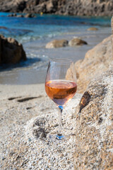 Summer time in Provence, glass of cold rose wine on sandy beach near Saint-Tropez, Var department, France
