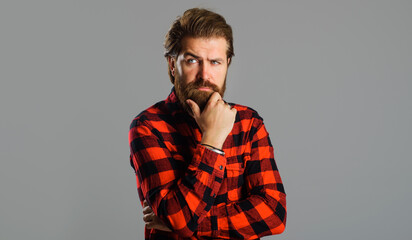 Pensive bearded man in plaid shirt. Thoughtful Handsome male. Solution of problem.