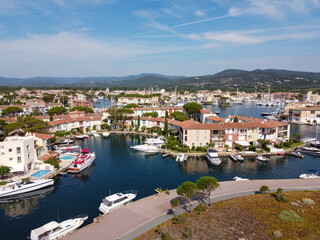 Fototapeta na wymiar Aerial view on small houses and sailboats of Port Grimaud and port Cogolin, French Riviera, Provence, France