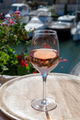 Summer on French Riviera Cote d'Azur, drinking cold rose wine from Cotes de Provence on outdoor terrase in Port Grimaud, Var, France
