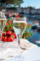 Summer party, pouring of French champagne sparkling wine in glasses in yacht harbour of Port Grimaud near Saint-Tropez, French Riviera vacation, France