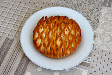 Wicker bun with cottage cheese on a plate