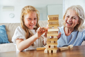 grandmother children granddaughter familiy childhood child senior creativity toy game wood brick...