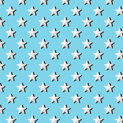 Pattern of white stars on a blue background, flat lay
