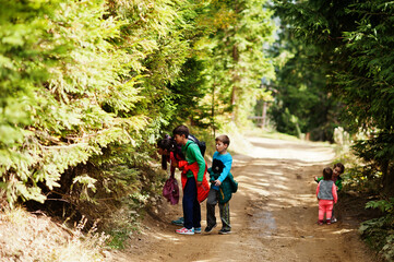 We found a mushroom! Mother with four kids resting in mountains. Family travel and hiking with childrens.