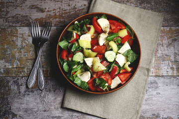 Healthy salad with vegetables and mozzarella. Diet food concept.