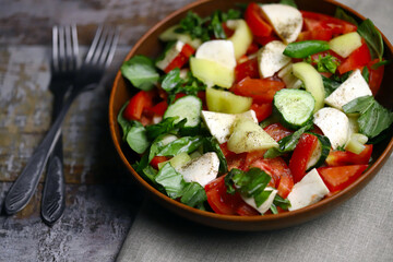 Healthy salad with vegetables and mozzarella. Diet food concept.