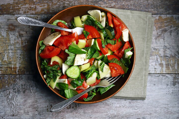 Healthy salad with vegetables and mozzarella. Diet food concept.