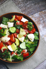 Healthy salad with vegetables and mozzarella. Diet food concept.
