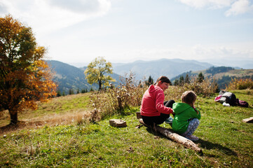 Fototapeta na wymiar Mother and child with enjoying in the mountains.The concept of family travel, adventure, and tourism. Lifestyle and hiking autumn vacations outdoor.