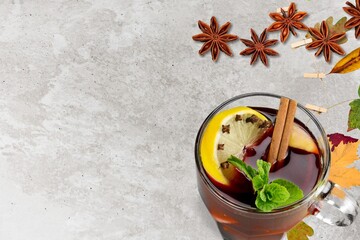 Hot tea or coffee with fall foliage, cinnamon sticks and star anise. Colorful autumn leaves