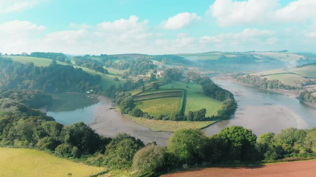 Aerial view of a bend in the river, with mist rising off the water, in Sharpham, Devon, UK
