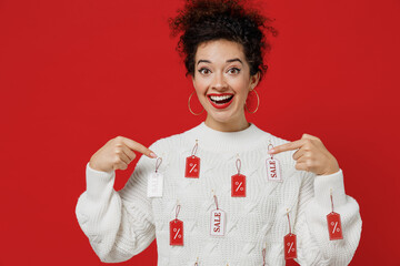 Young smiling surprised fun happy female costumer woman 20s wear white knitted sweater with tags...
