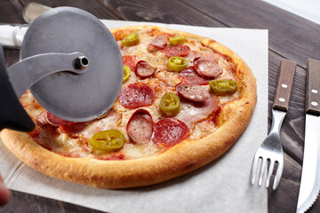 tasty pizza on the wooden background