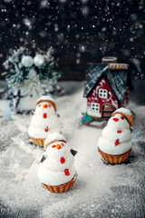 snowman made of sweet meringue with Christmas decorations. Original marshmallow and meringue cookies on the Christmas table. Cookies in the form of a snowman