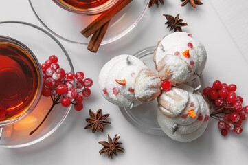 snowman made of sweet meringue with Christmas decorations. Original cookies with marshmallows and meringue on the Christmas table with tea. Cookies in the form of a snowman top view