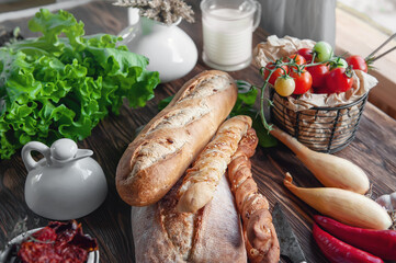 An assortment of different types of bread. Italian ciabatta bread, grissini with tomatoes, milk and...
