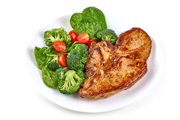 Roasted pork steaks with vegetable salad, isolated on white background.