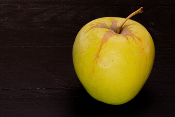 Green apple on black trees boards