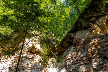 Mountain range, sources, hiking trail along the bank of a mountain river, natural stone, background, panoramic views of the mountainous terrain.