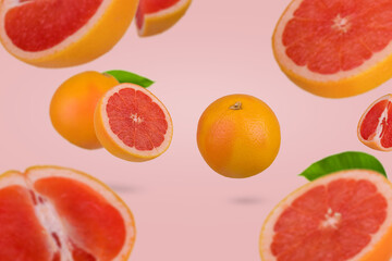 Fresh ripe sliced grapefruit floating in air isolated on pastel pink background. Minimal fruit concept.
