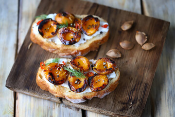 Delicious toast with cream cheese and grilled apricots. Healthy food. Apricot bruschetta.