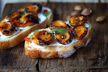 Delicious toast with cream cheese and grilled apricots. Healthy food. Apricot bruschetta.