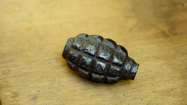 old rusty hand grenade rotating close-up