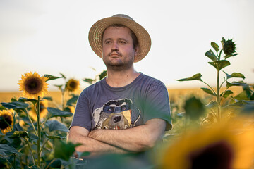 Male farmer on a field with sunflowers
