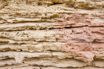 Stone antique old wall as a background or texture. Vintage background of a fortress wall in loft and grunge style with place for text and copy space.