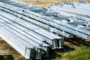 stack of galvanized metal structures on the ground at the construction site