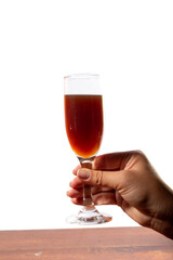 Red wine glass on a hand against a white background
