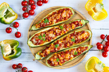 Zucchini stuffed with meat stuffing and corn baked with mozzarella