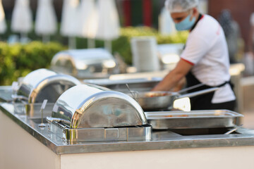 Catering during a pandemic. Masked chef restaurant
