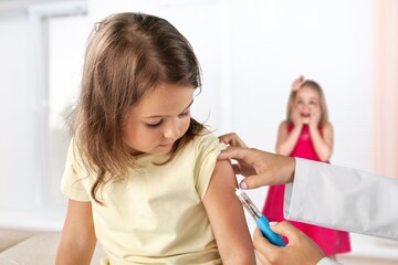 Little Girl Getting Vaccinated Against Covid, Doctor Applying