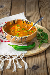 Romanian traditional beef soup served in clay bowl. In romanian is called "ciorba de vacuta".