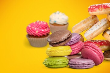 Confectionery and sweets collage. Donuts, cupcakes, cookies, macarons on the desk