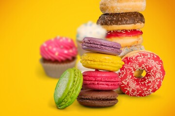 Confectionery and sweets collage. Donuts, cupcakes, cookies, macarons on the desk