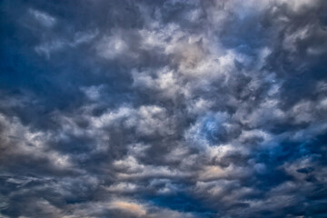 Fototapeta premium Beautiful epic texture of gray clouds with dramatic lighting in uniform frame