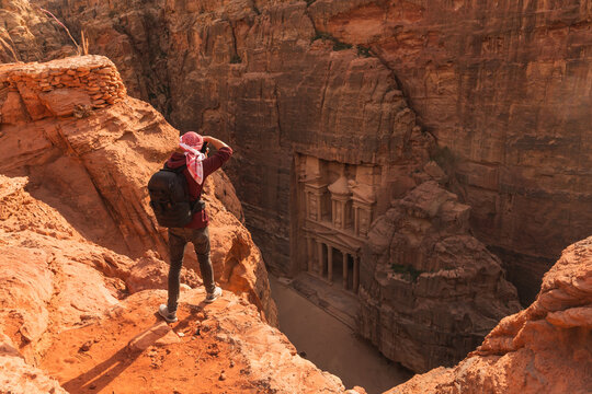 Man standing on top of mountain stone.