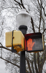 Urban City pedestrian crosswalk safety sign signal with bright orange hand
