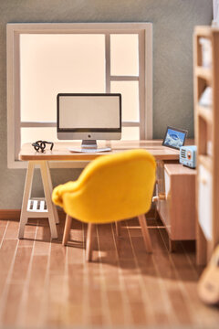 Papercraft room with computer on table and chair