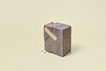 Broken stone with adhesive plaster