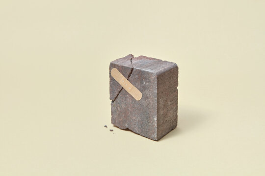 Broken stone with adhesive plaster