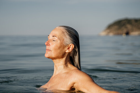 Portrait of beautiful mature woman swimming in the sea