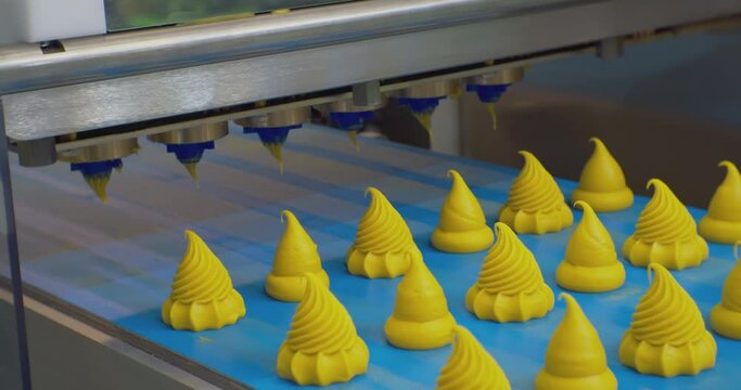 modern food production.cream cakes move along the production line.close-up.