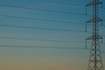 High voltage power line against the sky. Place for your text. Golden hour.